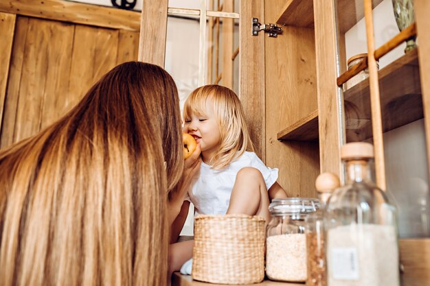 Little girl helping mom in the kitchen