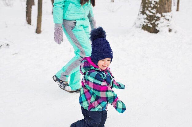 Little girl and her mom having fun on a winter day.