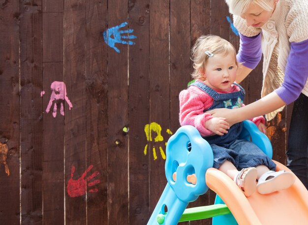 Little girl and her mother having fun with a chute