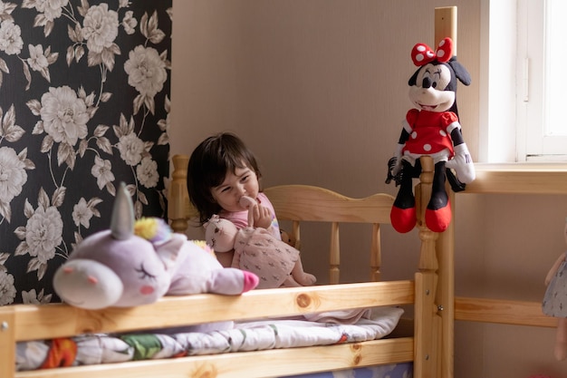 little girl in her room playing with her toys and stuffed animals