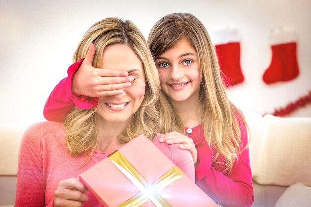 Little girl hiding gift from mother at home in the living room