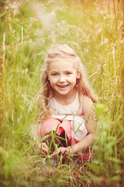 Little girl hiding in high grass