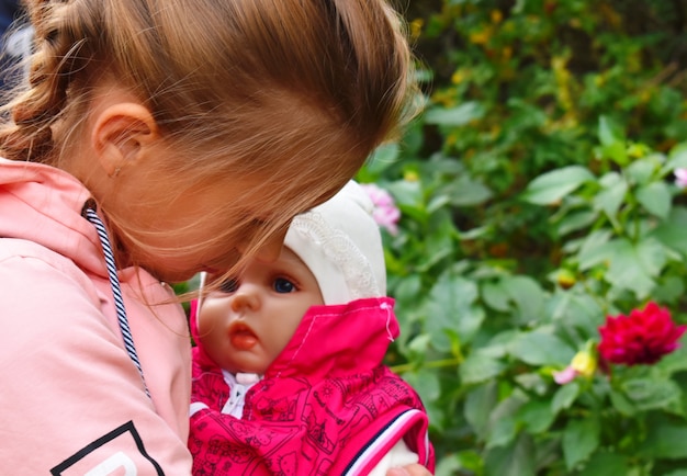 Little girl holding a baby doll