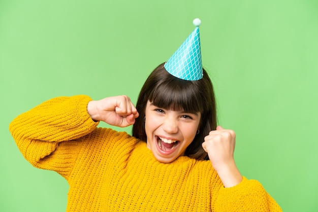 Little girl holding birthday cake over isolated chroma key background