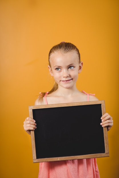 Little girl holding a blackboard