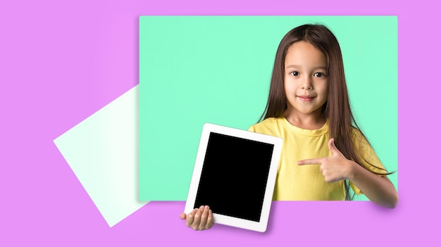 Little girl holding a blank tablet computer