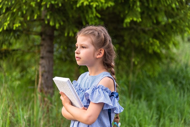 A little girl holding a book