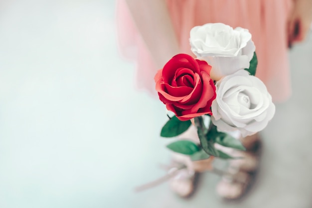 Little girl holding a bouquet of beautiful roses