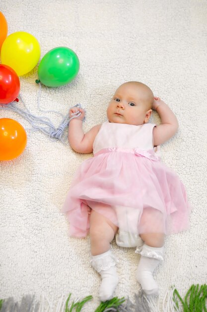 Little girl holding a bunch of balloons and flight shows