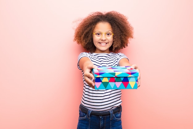 Little girl holding a gift box