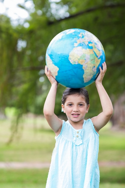 Little girl holding a globe