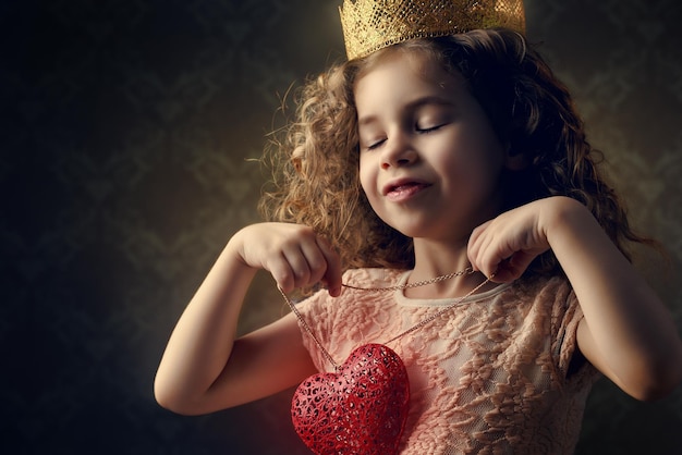 Little girl holding a heart