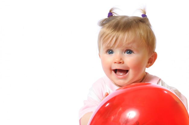 Little girl holding red balloon