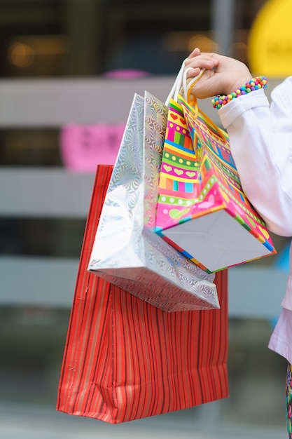 Little girl holding shopping bags