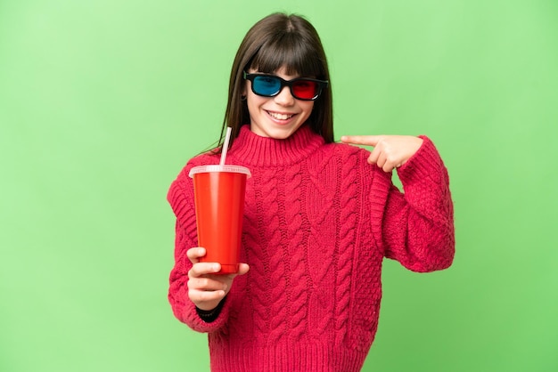 Little girl holding soda over isolated chroma key background giving a thumbs up gesture