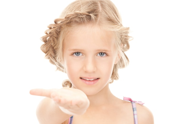 little girl holding something on the palm of her hand