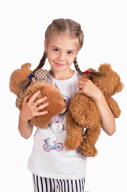 Photo little girl holding a teddy bear