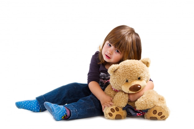 Little girl holding a teddy bear