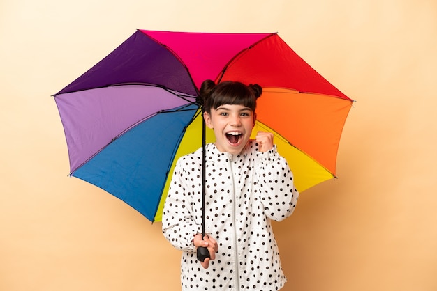 Little girl holding an umbrella isolated