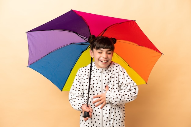 Little girl holding an umbrella isolated