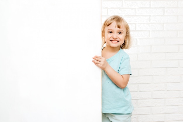 Little girl holding a white sign or poster