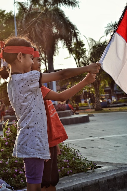 a little girl holds a flag that says " peace ".