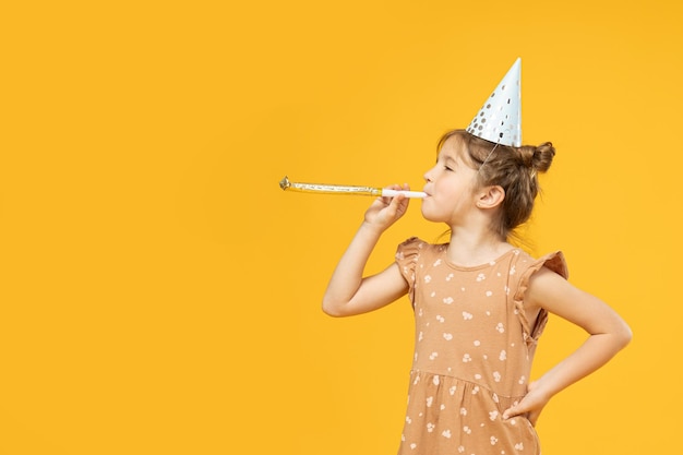 A little girl in a holiday cap with a pipe