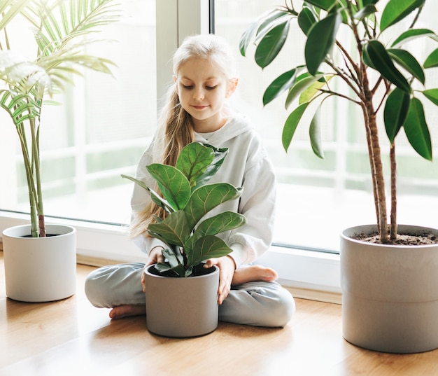 Little girl and houseplants