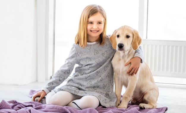 Little girl hugging dog