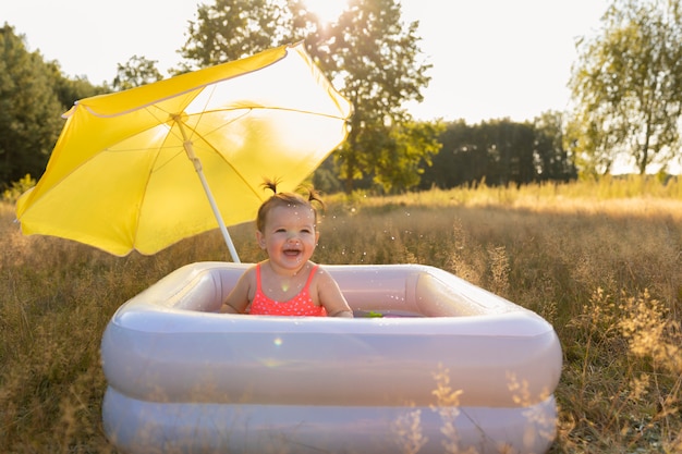 Little girl in an inflatable pool.