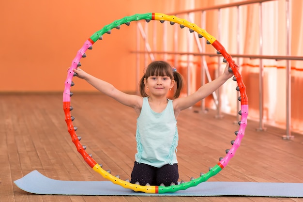 A little girl is 5 years old in the gym.