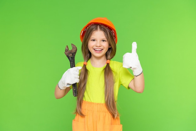 A little girl is going to make repairs in her children's room. construction works. Renovation of the premises. Isolated background.