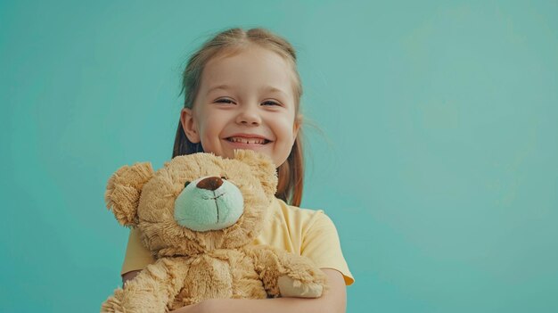A little girl is holding a teddy bear