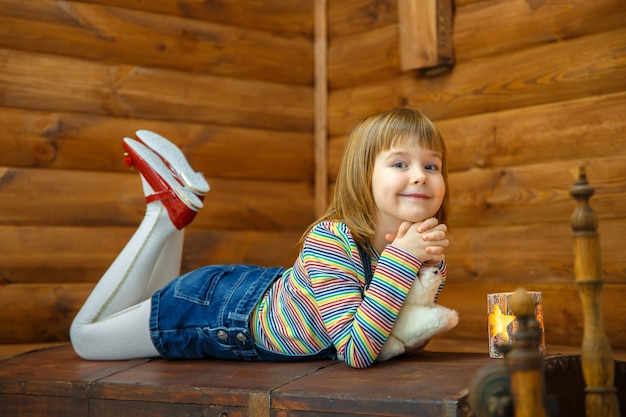 Little girl is lying on old chest