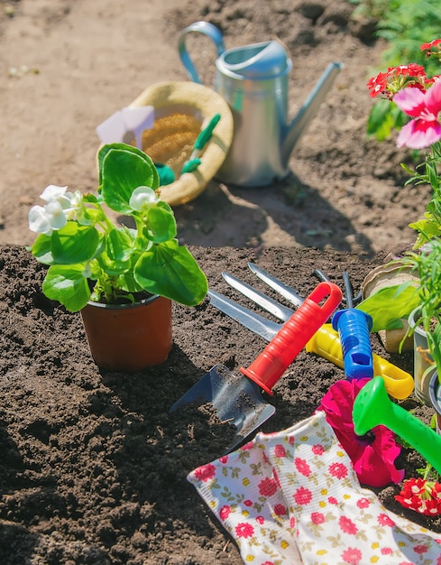 A little girl is planting flowers.  