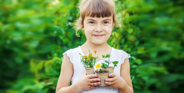 A little girl is planting flowers