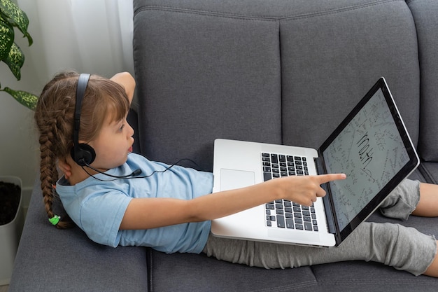 A little girl is studying online. Quarantine. Online.