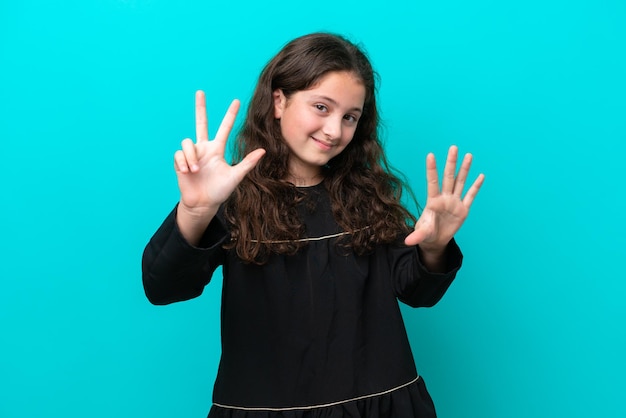 Little girl isolated on blue background counting eight with fingers