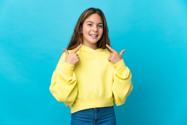 Little girl over isolated blue background giving a thumbs up gesture