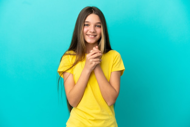 Little girl over isolated blue background laughing