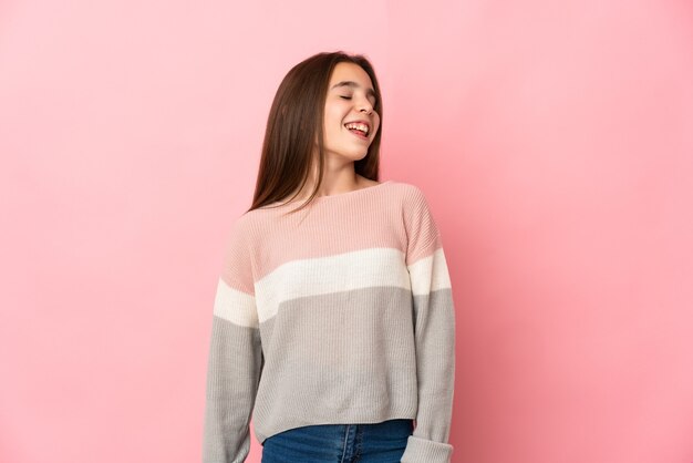 Little girl isolated on pink background laughing