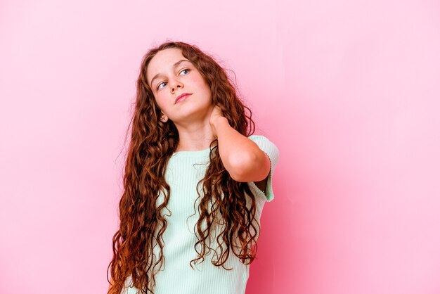 Little girl isolated on pink wall having a neck pain due to stress, massaging and touching it with hand