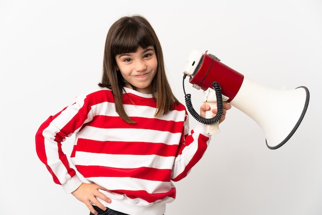 Photo little girl isolated on white background holding a megaphone and thinking