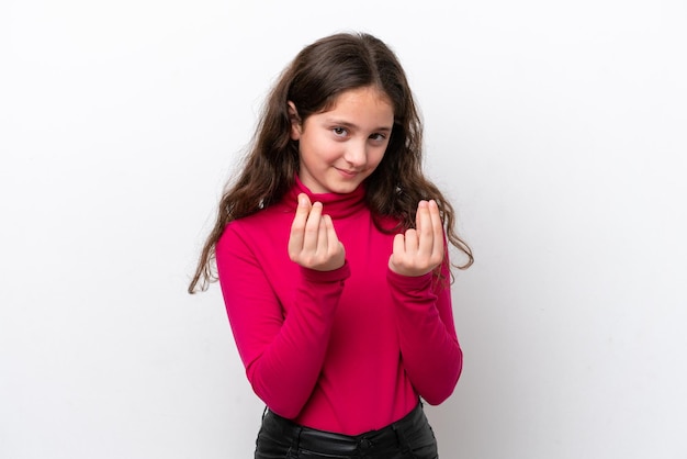 Little girl isolated on white background making money gesture