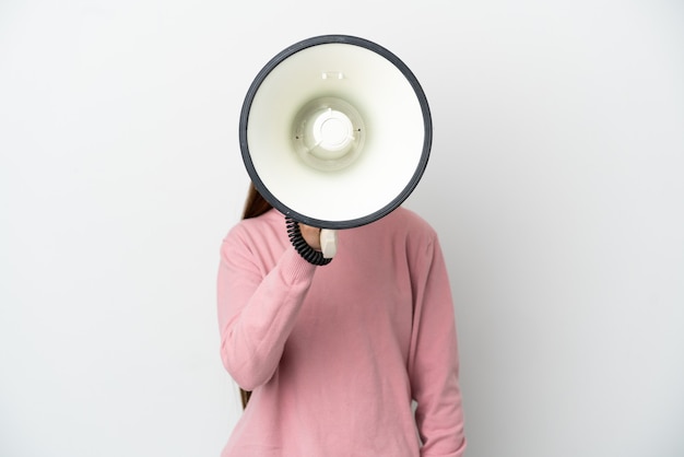 Photo little girl over isolated white background shouting through a megaphone to announce something