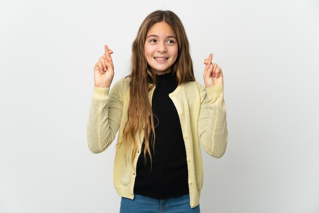 Little girl over isolated white background with fingers crossing and wishing the best