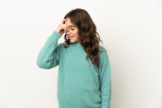 Little girl isolated on white wall laughing