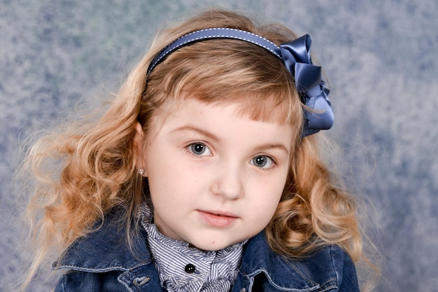 Little girl in jeans jacket posing