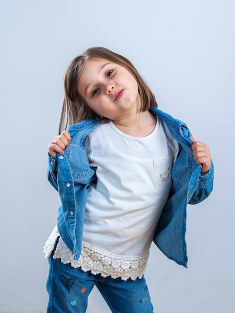 Little girl in jeans posing for the camera