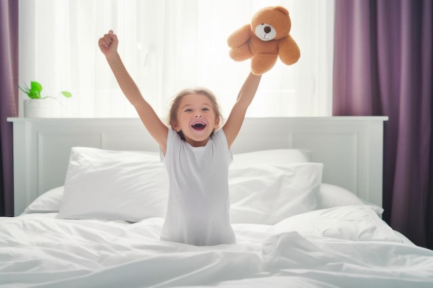 a little girl jumping on a bed with a teddy bear